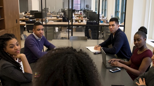 a group of people sitting around a table