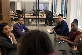 a group of people sitting around a table