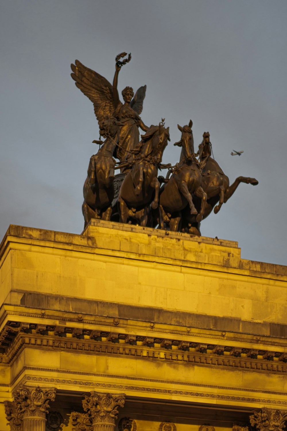 a statue of a man on a horse on top of a building