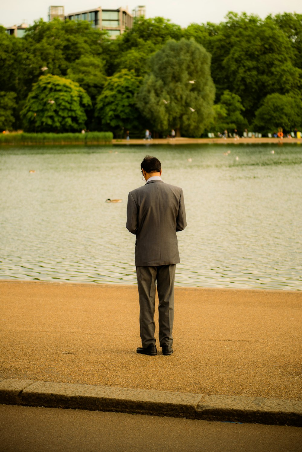 a man in a suit looking at the water