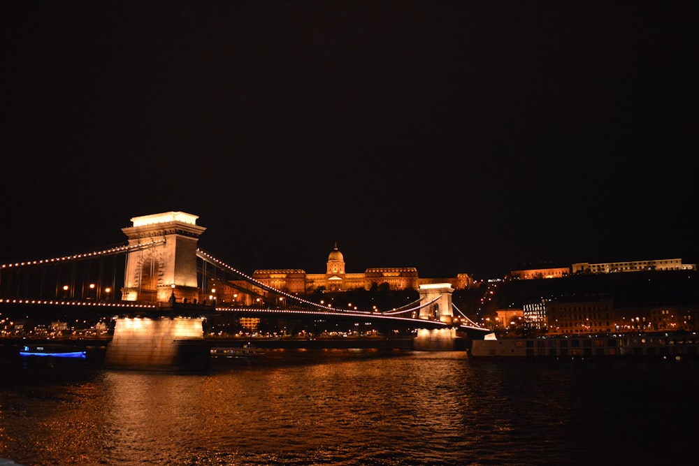 a night view of a bridge over a body of water