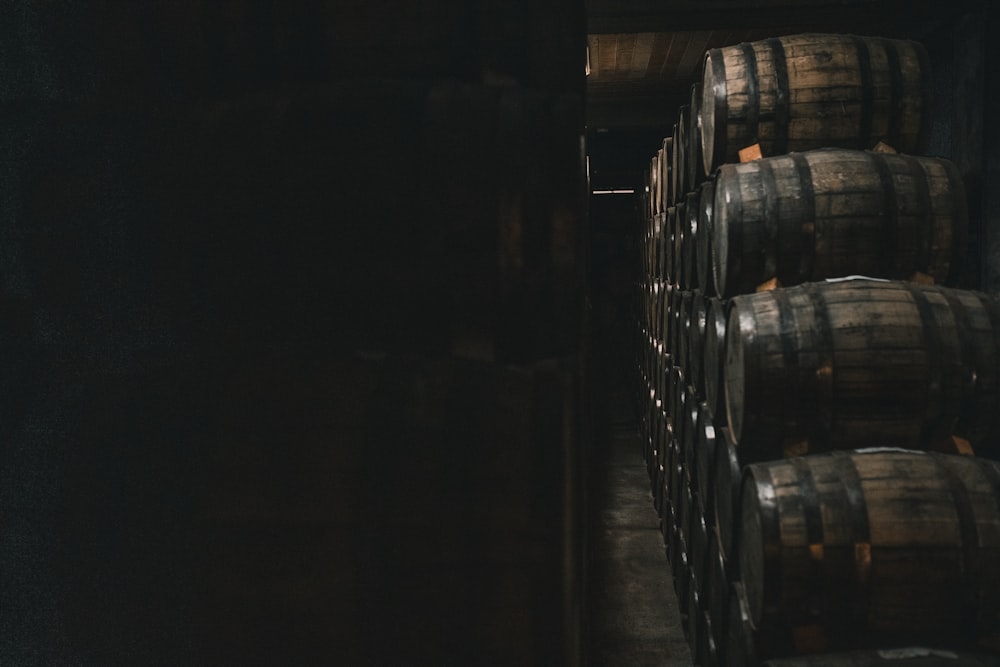 a bunch of wooden barrels stacked on top of each other