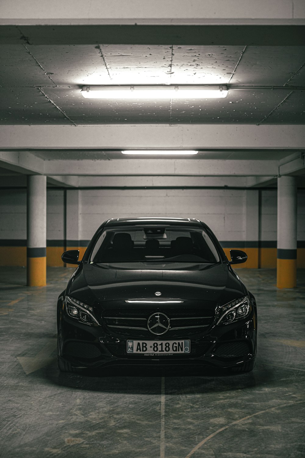 a black car parked in a parking garage