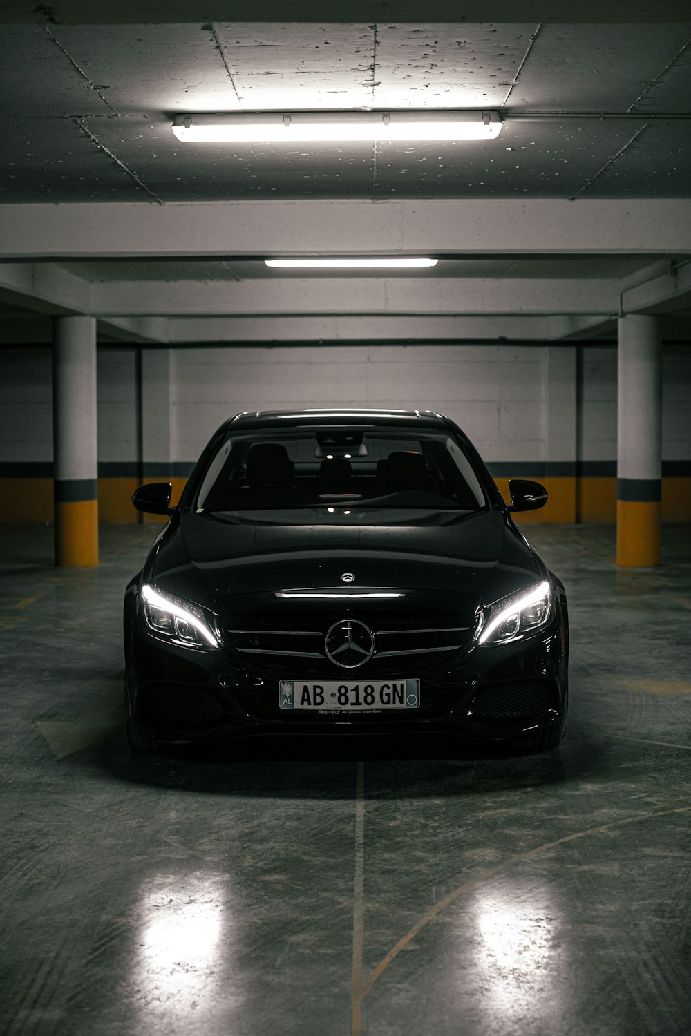 a black car parked in a parking garage