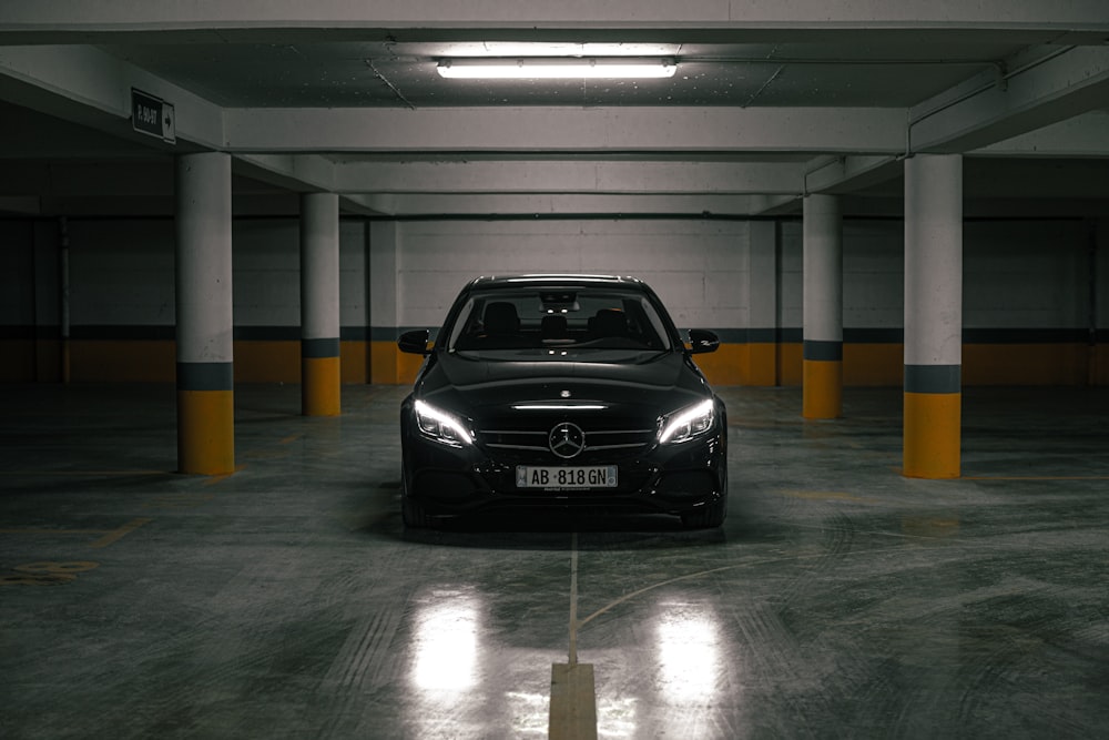 a black car parked in a parking garage