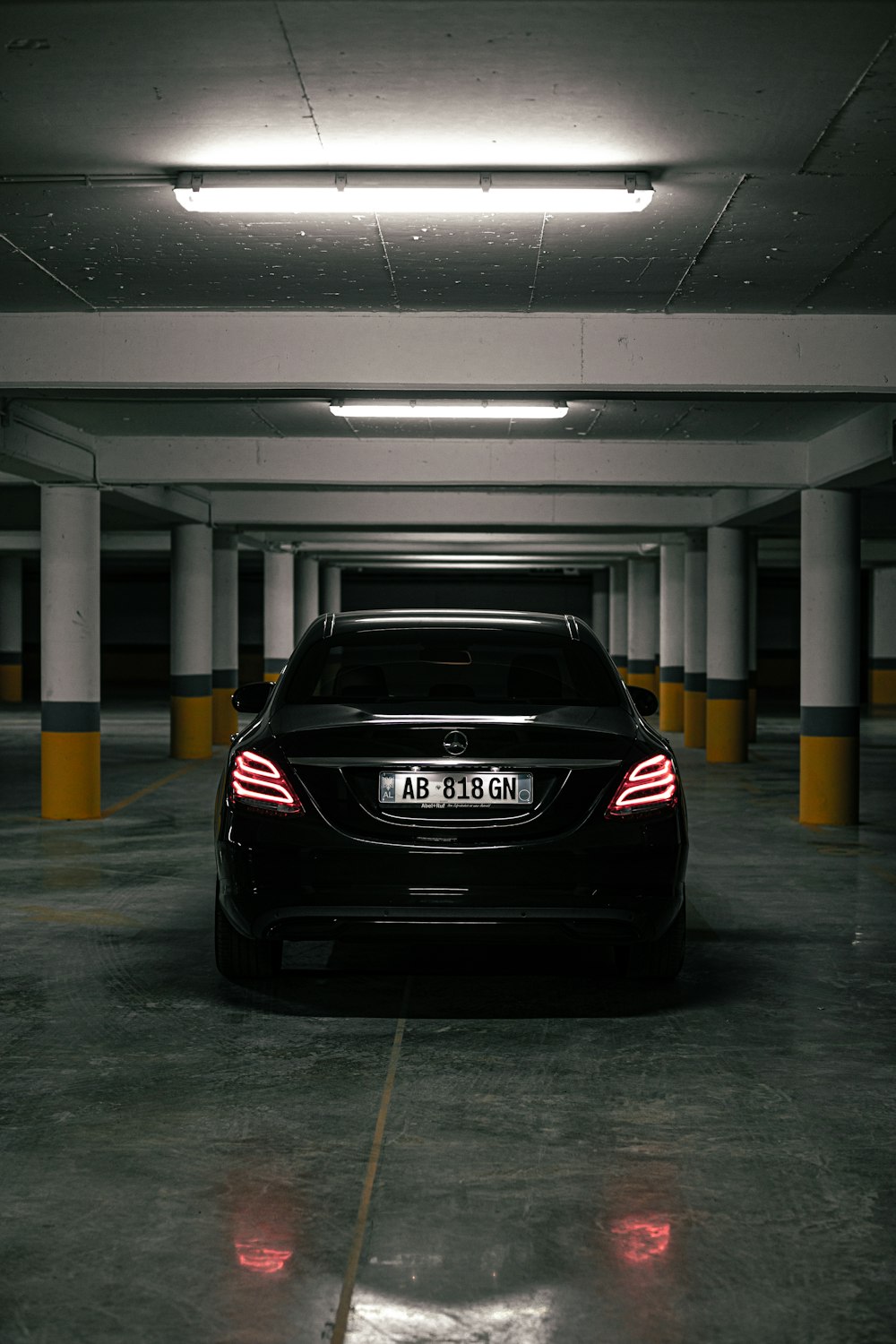 a black car parked in a parking garage