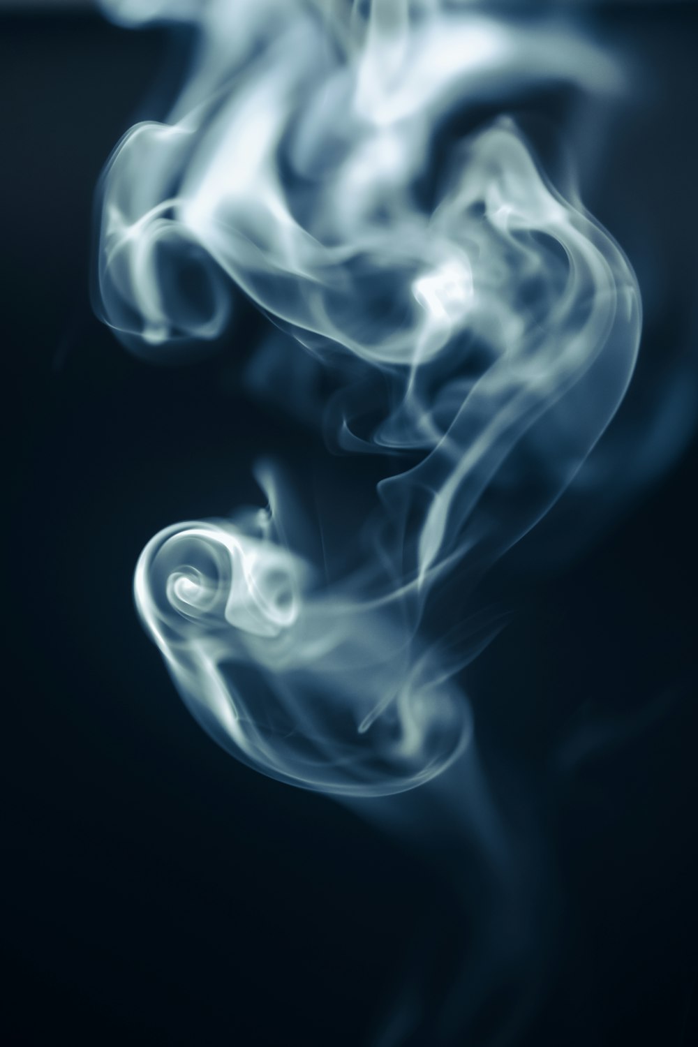 a blurry photo of smoke on a black background