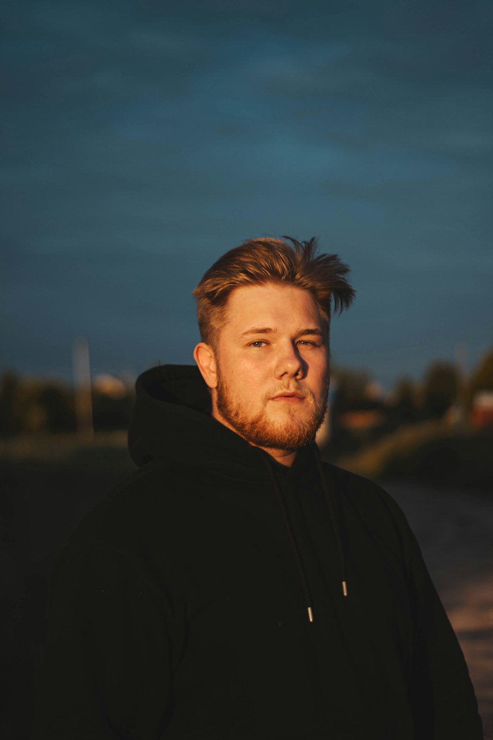 a man with a beard and a black hoodie