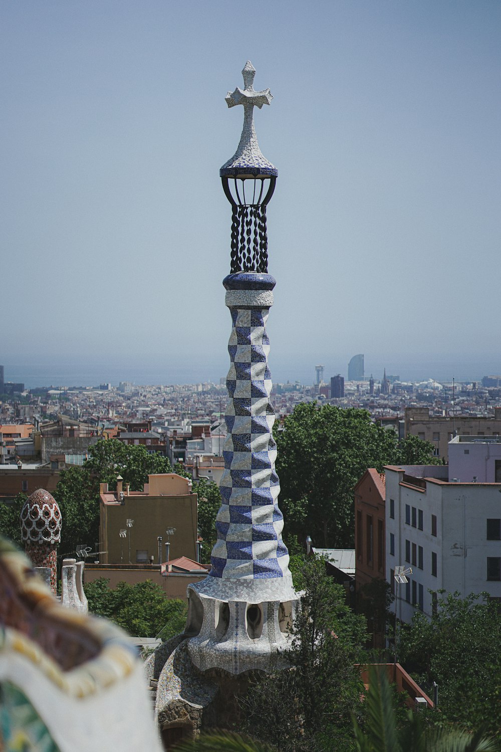 a tall tower with a cross on top of it