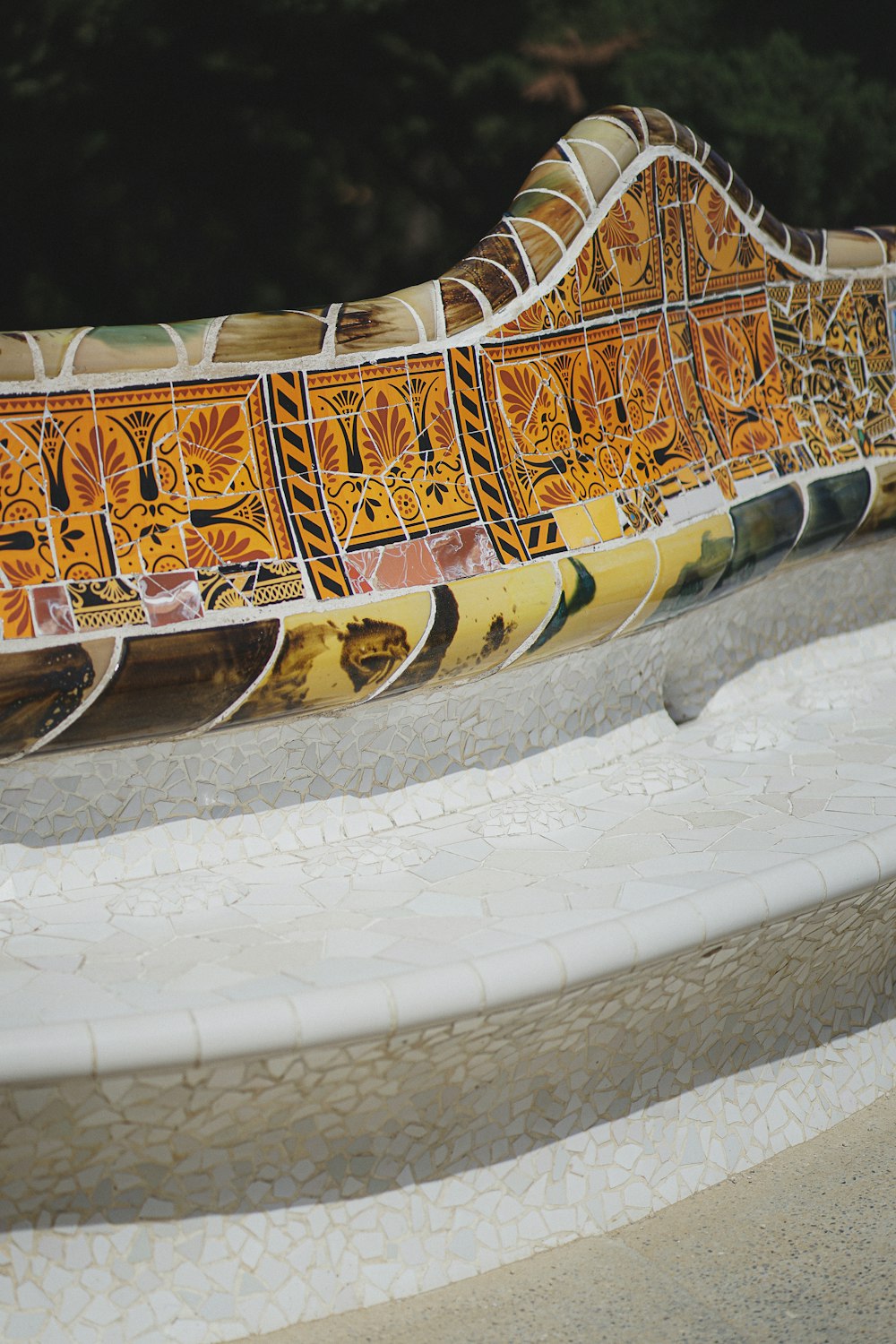 a close up of a bench made out of tiles