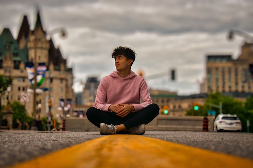 a man sitting in the middle of a street