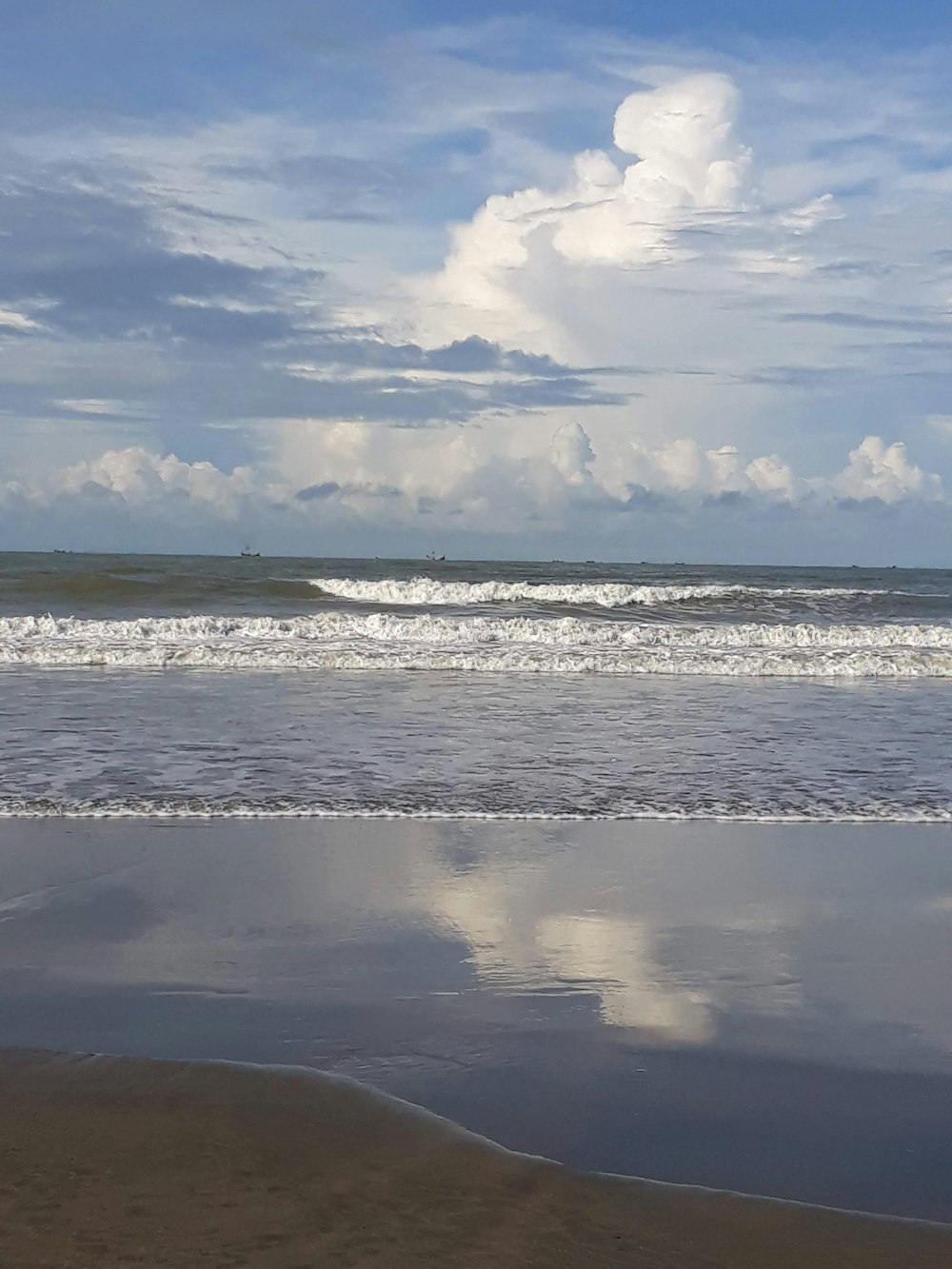 a person walking on the beach with a surfboard