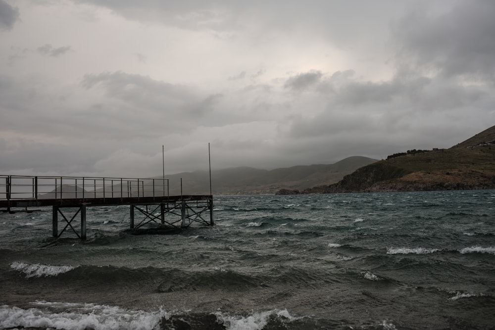 a pier in the middle of a body of water