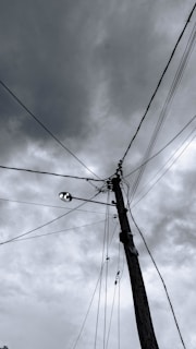 a black and white photo of a telephone pole