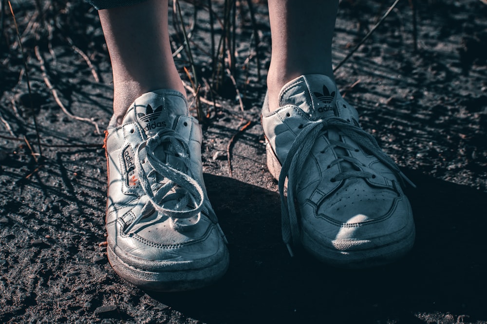 a person standing on the ground with their shoes on