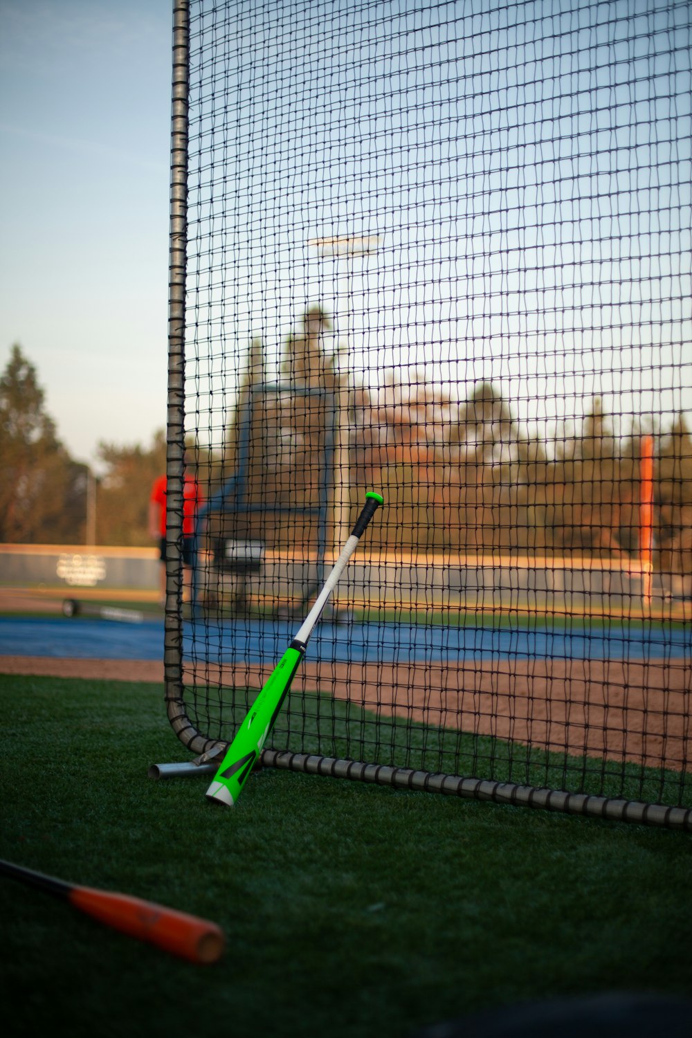 a baseball bat laying on top of a green field
