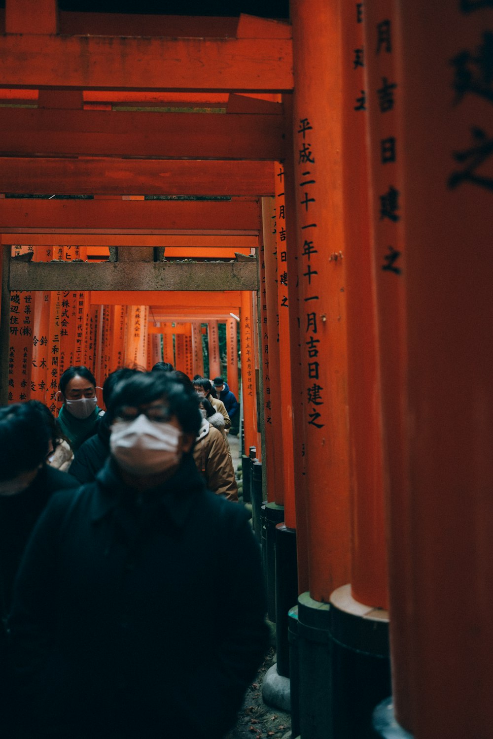 a group of people wearing masks walking through a tunnel