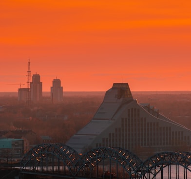 a bridge over a body of water with a city in the background