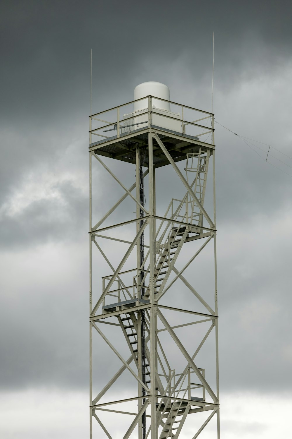 a tall metal tower with a sky background