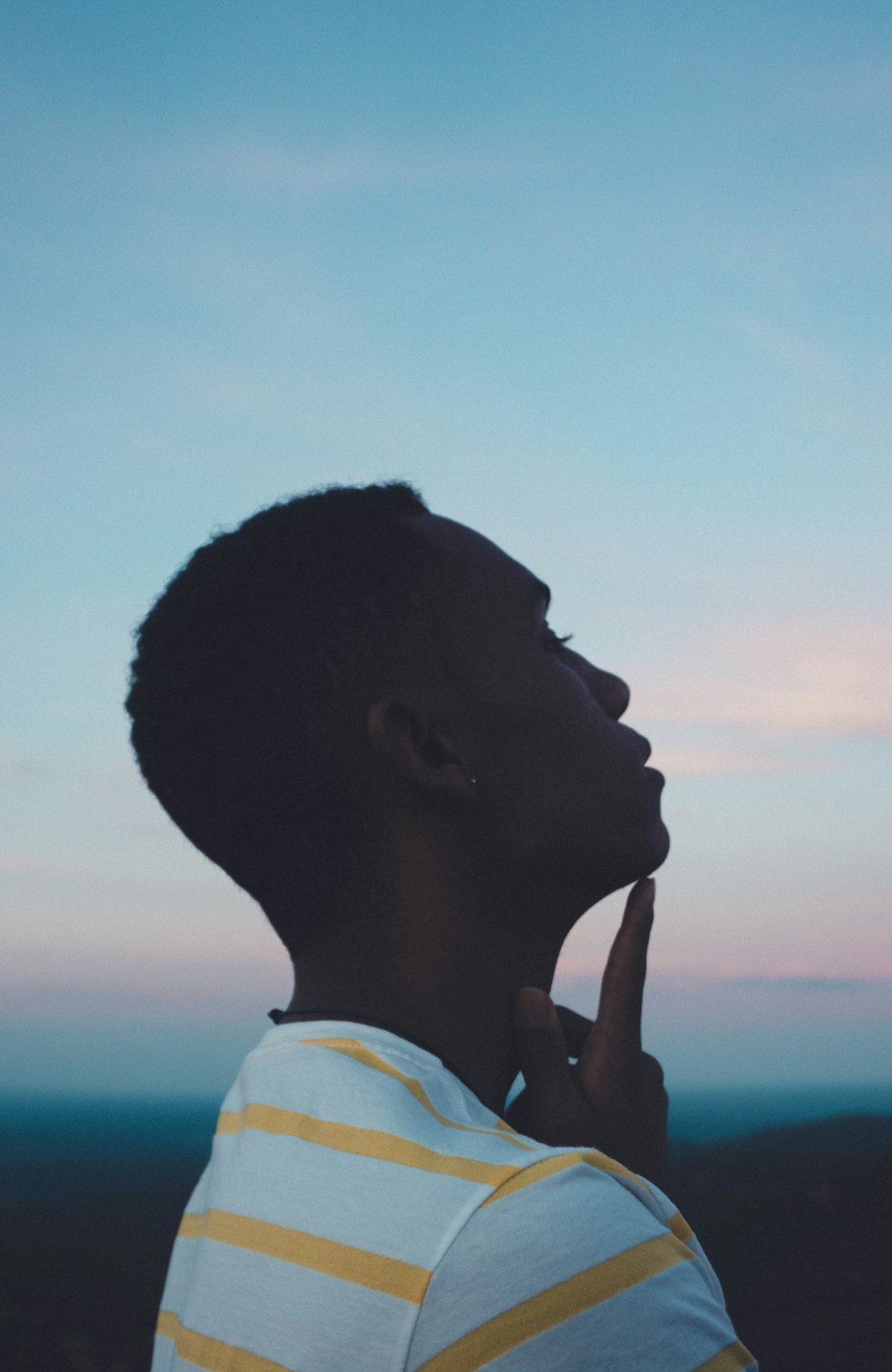 a man standing in front of a blue sky