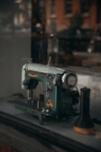 Close-up of a restored antique sewing machine's intricate metalwork gleaming under soft light.