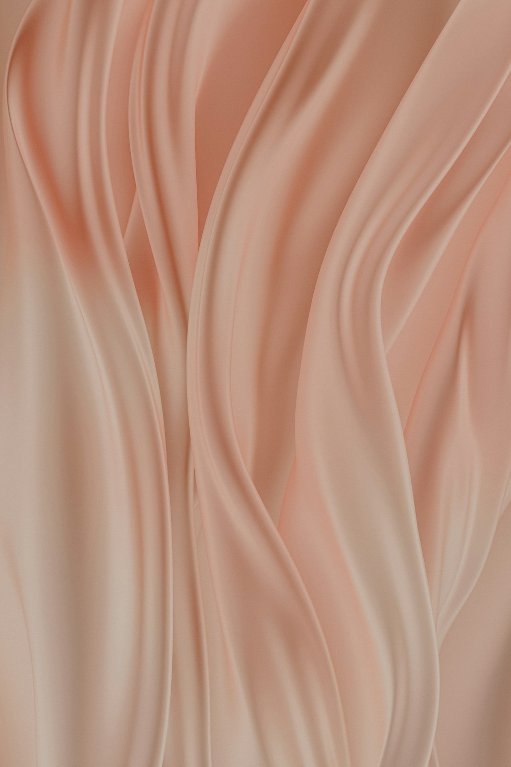 波状の折り目を持つ柔らかいピンクの背景