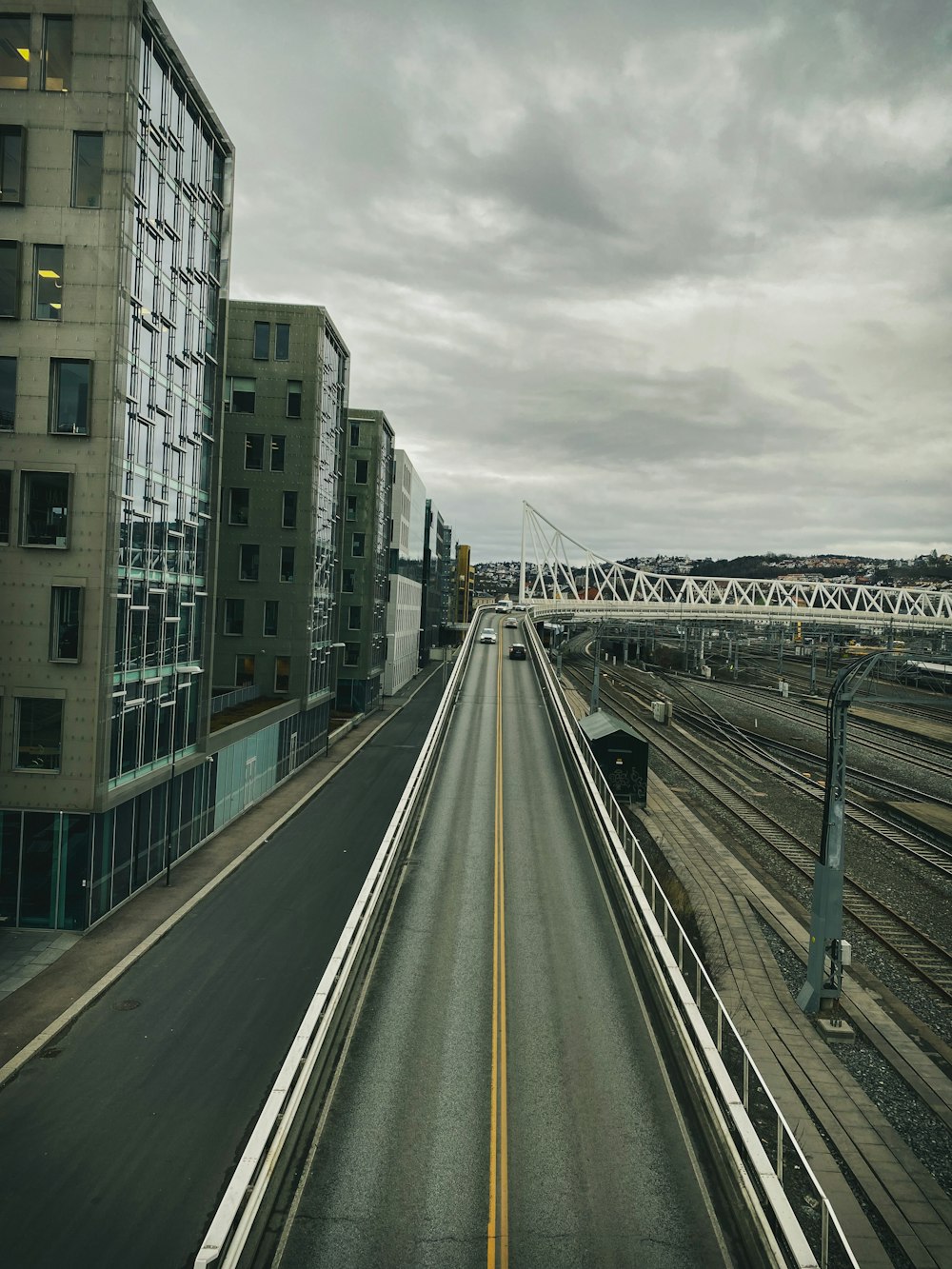 a long stretch of road with a bridge in the background