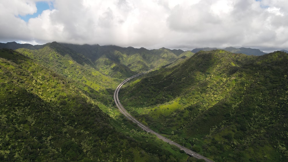 an aerial view of a winding road in the mountains