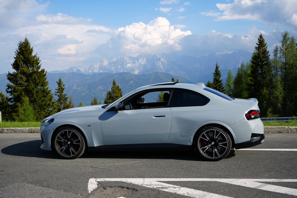 a white sports car parked on the side of the road