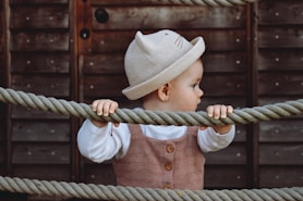 a small child is holding on to a rope