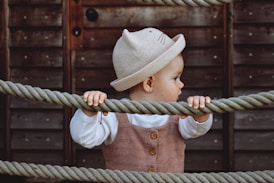 a small child is holding on to a rope