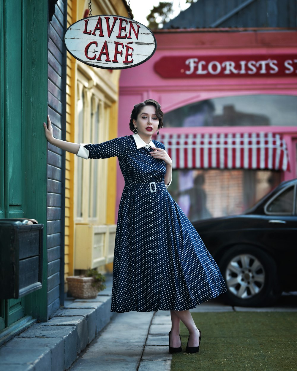 a woman in a blue dress is holding a sign