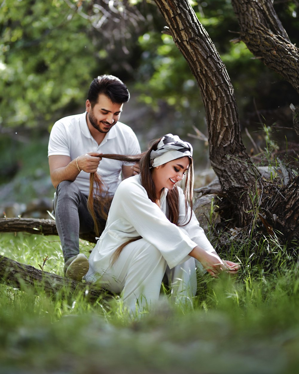 a man kneeling next to a woman in a field