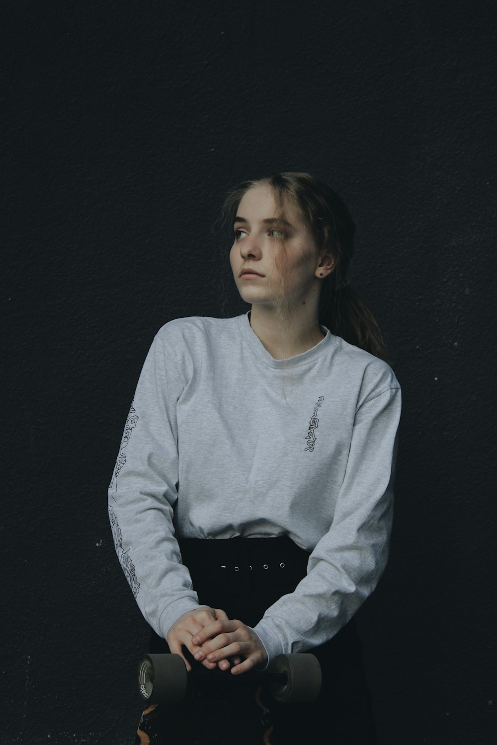 a woman in a white shirt and black skirt