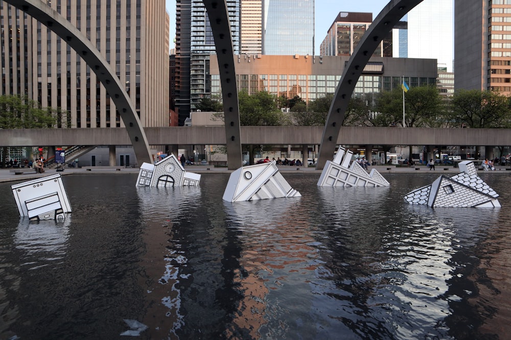 a group of paper boats floating on top of a body of water