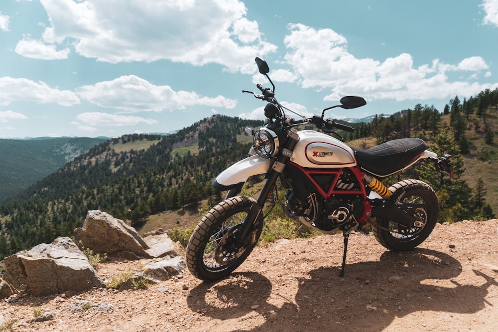 a motorcycle parked on top of a dirt hill