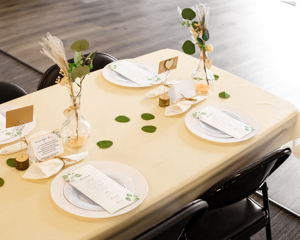 a table set with place settings and place cards