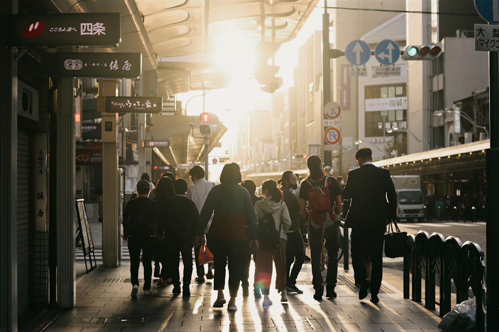 a group of people walking down a city street