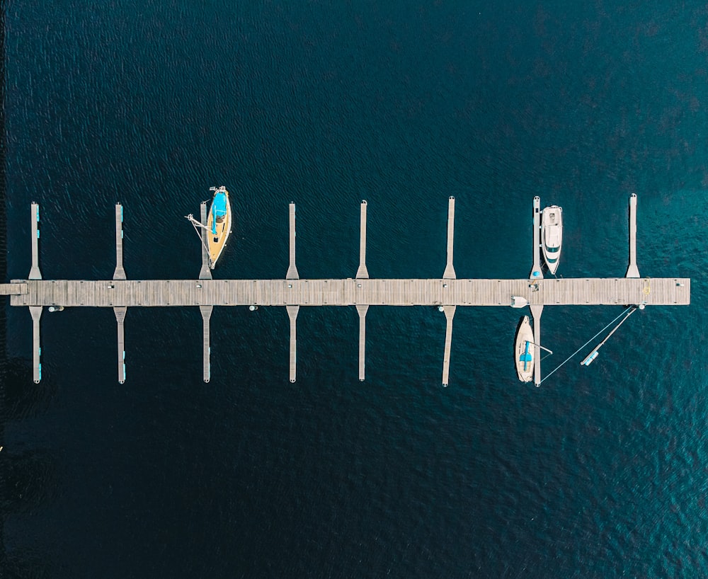 a pier with two boats on it and a man on a surfboard