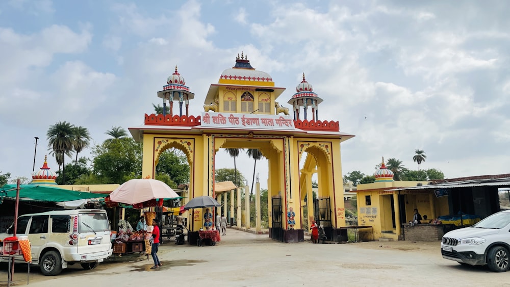 a car parked in front of a yellow gate