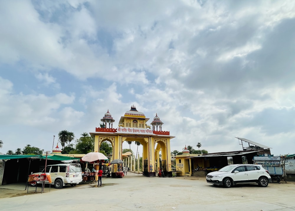 a white car parked in front of a yellow building