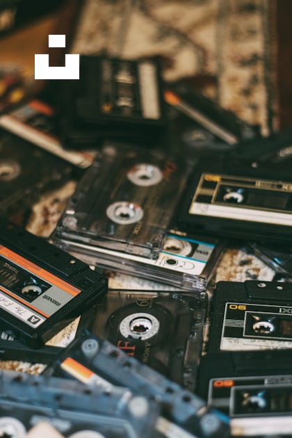 A pile of old cassettes sitting on top of a table photo – Free United ...