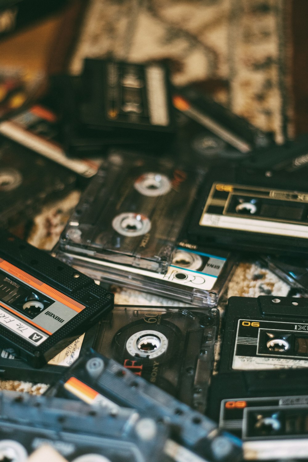 a pile of old cassettes sitting on top of a table