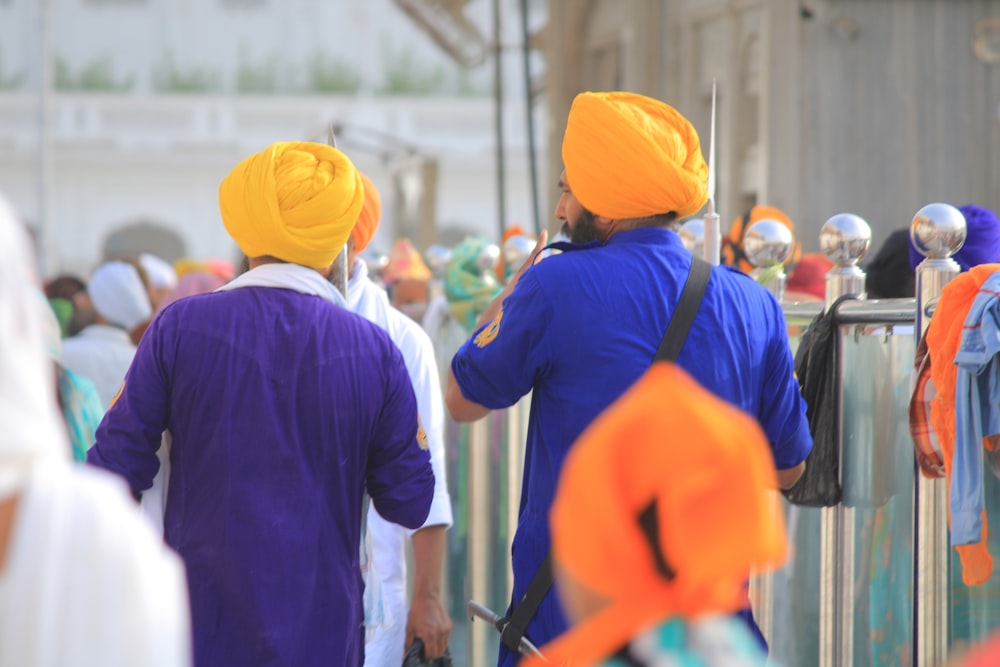 a group of men in turbans walking down a street