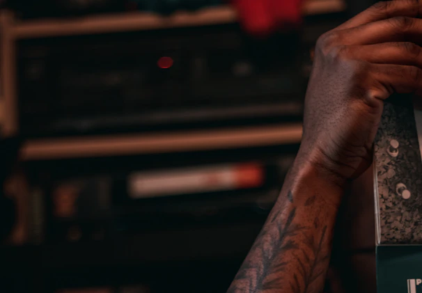 A close-up of Brent Silveria's hands carefully packaging a print with recycled materials in a cozy studio.