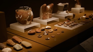 a table topped with lots of vases and rocks