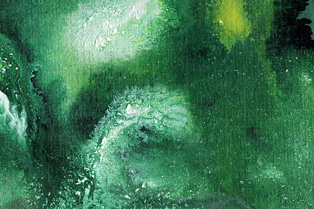 a close up of a green painting with water droplets