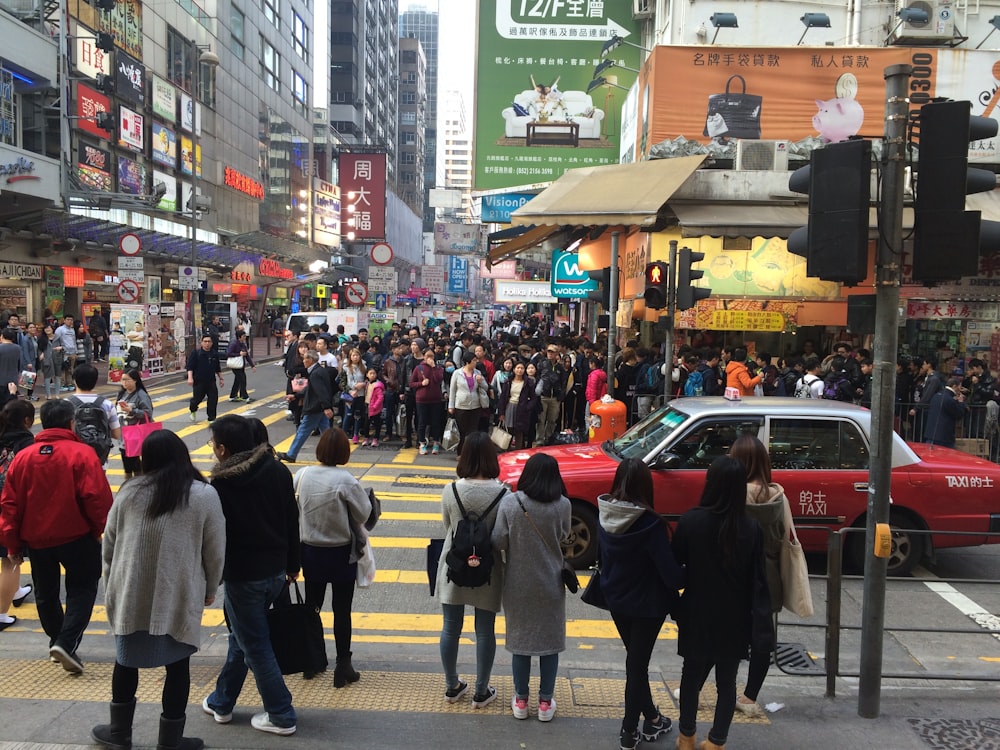 a crowd of people walking across a street