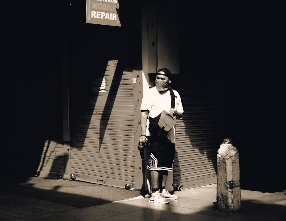 a man standing on a sidewalk next to a fire hydrant