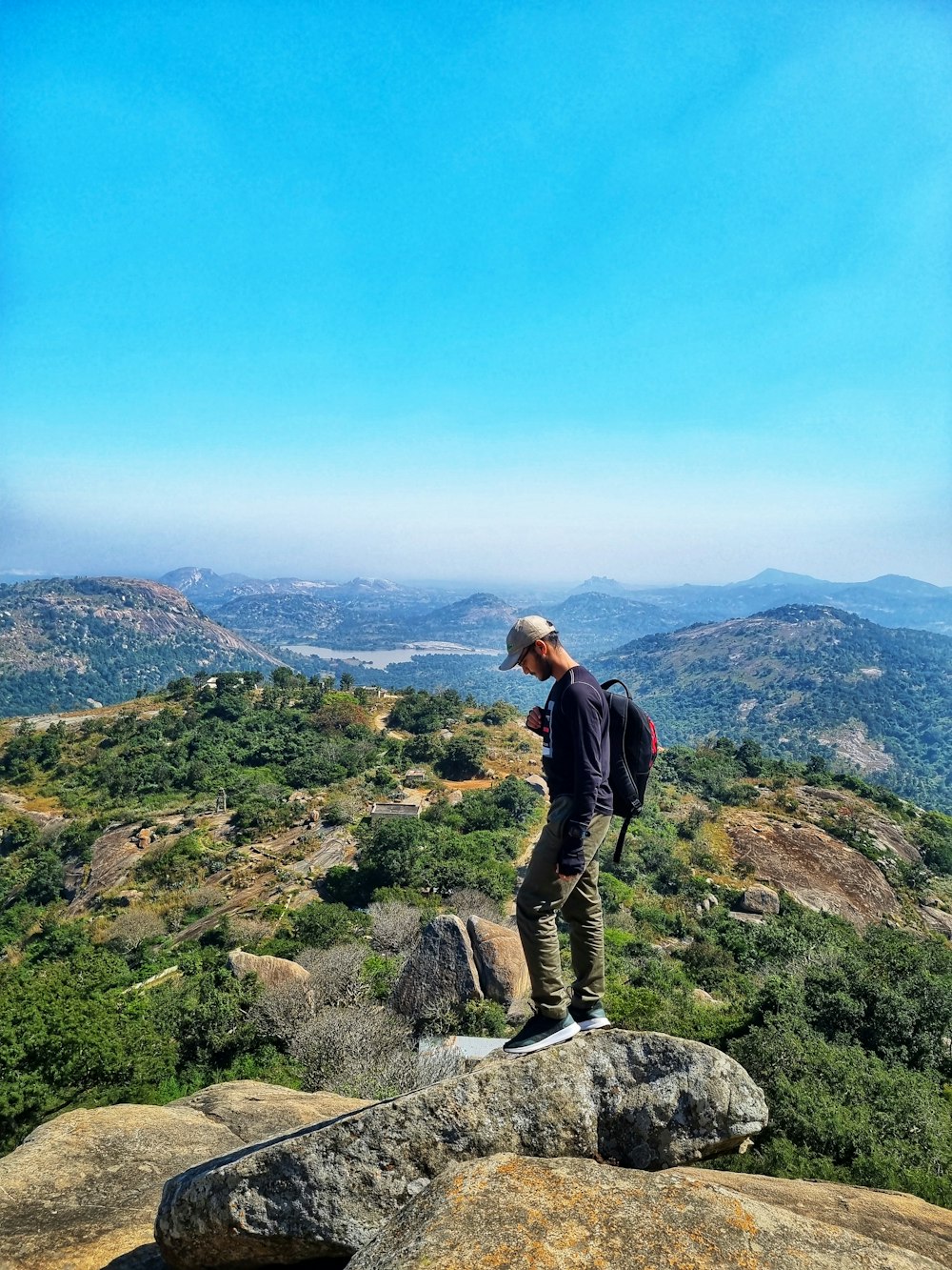 a man standing on top of a large rock